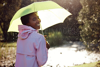 Buy stock photo Happy, portrait and black woman with an umbrella in the rain for insurance and covering in nature. Smile, happiness and an African person with tools for winter cover, protection and walking in a park
