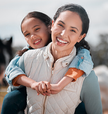 Buy stock photo Shot of a little girl and mother spending time together on a ranch