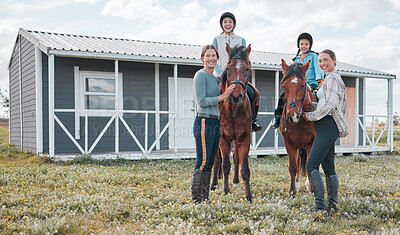 Buy stock photo Shot of two female instructors taking a woman and her daughter horse riding