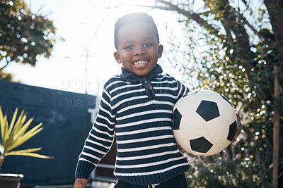 Buy stock photo Portrait, smile and African child with soccer ball outdoor for sport, exercise and playing at backyard in Kenya. Face, cute and happy kid with football at park for game, summer and healthy training