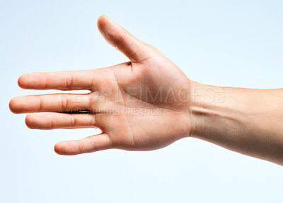 Buy stock photo Shot of an unrecognizable man holding out his hand for a handshake against a white background