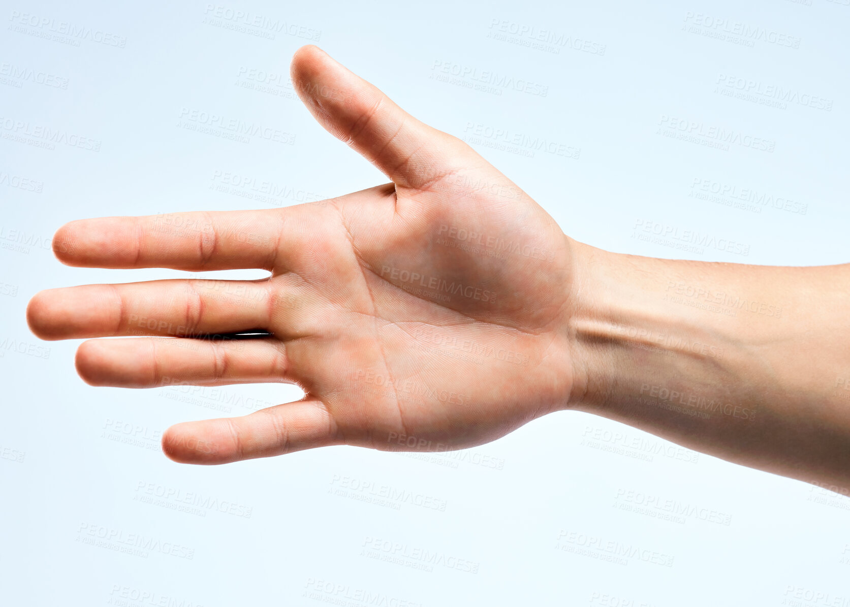 Buy stock photo Shot of an unrecognizable man holding out his hand for a handshake against a white background