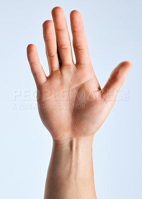 Buy stock photo Shot of an unrecognizable man showing his palm against a white background