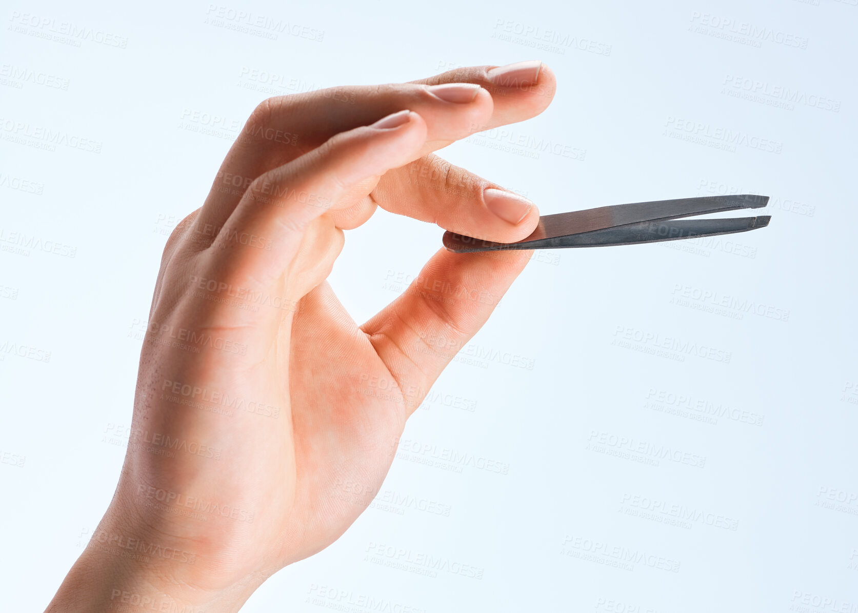 Buy stock photo Shot of an unrecognizable man holding a tweezer against a white background