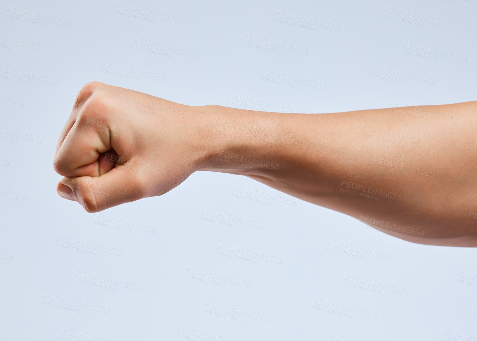 Buy stock photo Shot of an unrecognizable man holding his fist up against a white background