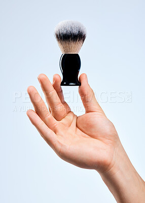 Buy stock photo Shot of an unrecognizable man holding a brush against a white background