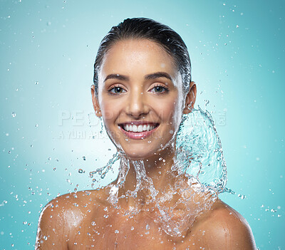 Buy stock photo Shot of a young woman taking a shower against a blue background