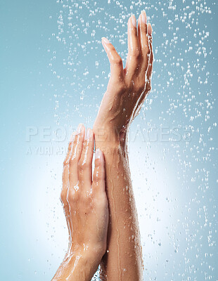 Buy stock photo Cropped shot of an unrecognisable woman showering against a blue background
