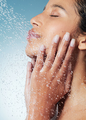 Buy stock photo Cropped shot of an attractive young woman showering against a blue background