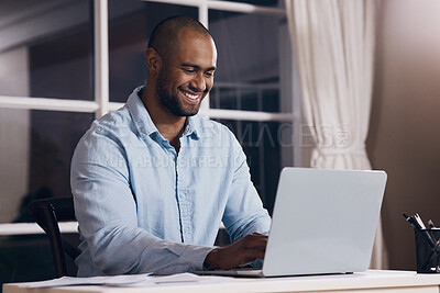 Buy stock photo Shot of a young businessman working using his laptop at night