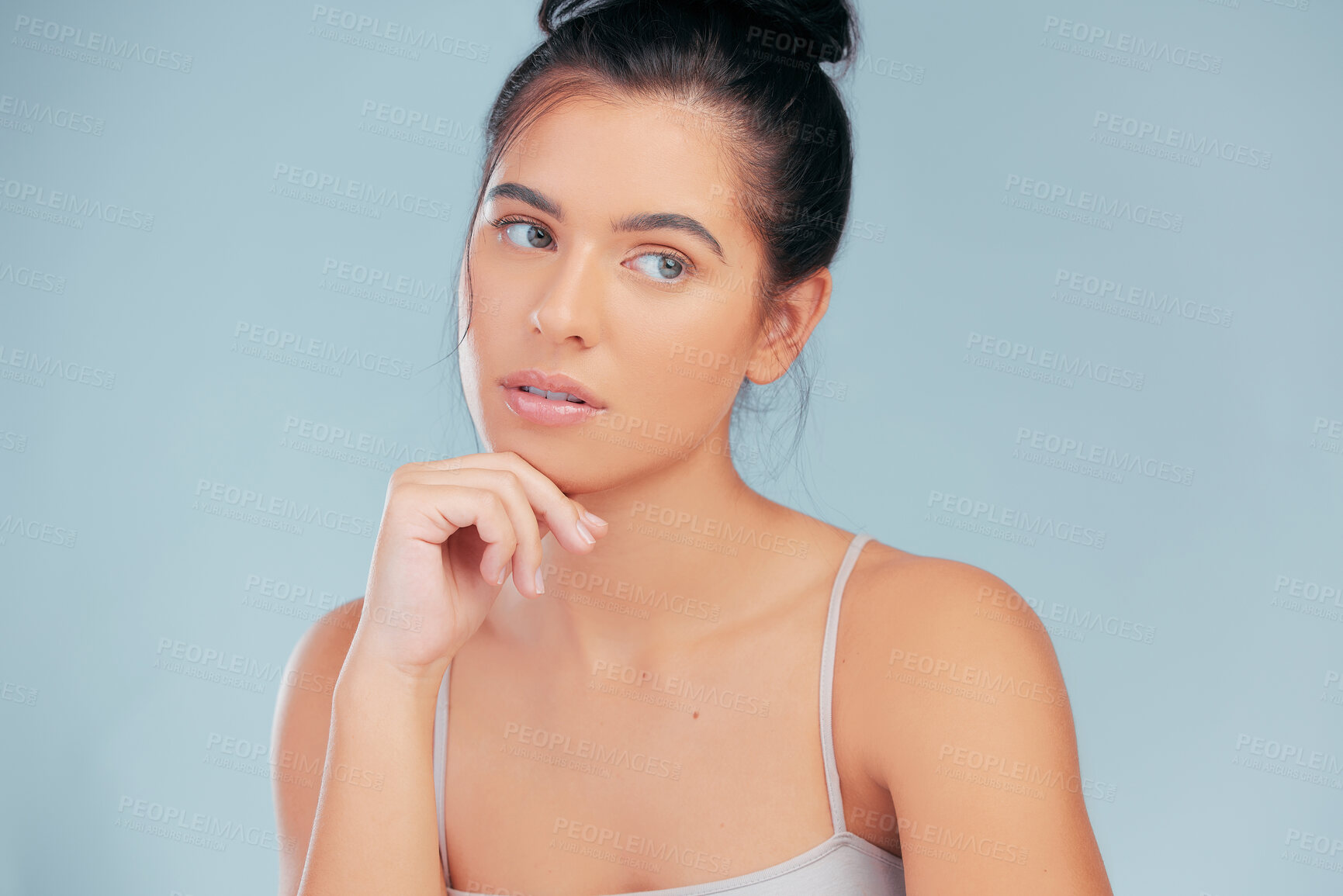 Buy stock photo Woman, thinking and natural beauty in studio for skincare, cosmetics and wellness on blue backdrop. Daydreaming, face and female person isolated by background for dermatology, self care and routine