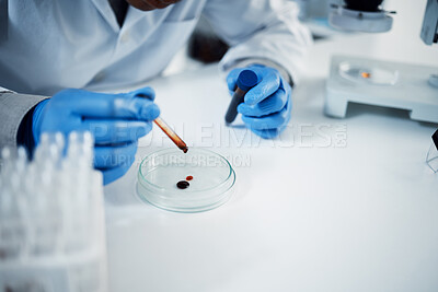 Buy stock photo Shot of a scientist conducting medical research on blood in a laboratory