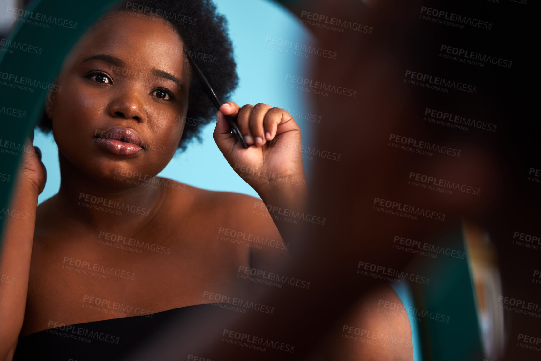 Buy stock photo Mirror, comb and black woman with hair care in studio for natural, afro and salon treatment. Beauty, health and African model with brush for curly hairstyle routine with reflection by blue background