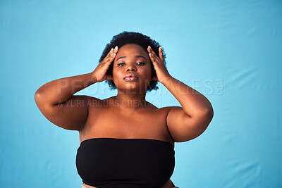 Buy stock photo Black woman, studio and hair care with natural or portrait for aesthetics, afro with moisture for wellness. Person, blue background or glow with hairstyle for cosmetic, plus size with confidence