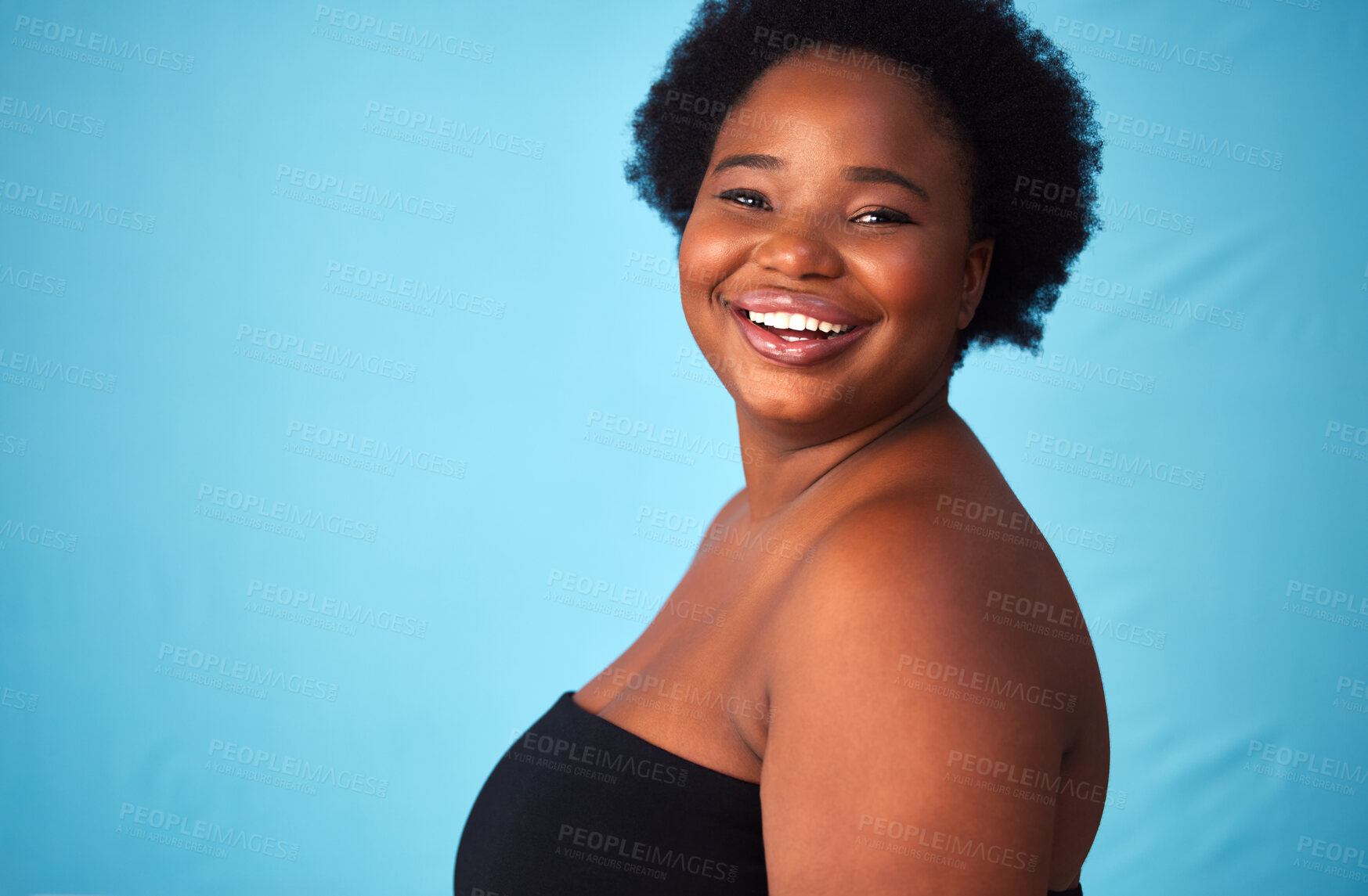 Buy stock photo Black woman, smile and plus size for portrait in studio with hair or natural afro, moisture and beauty on mockup space. Happy, confident and female person for self care cosmetics on blue background