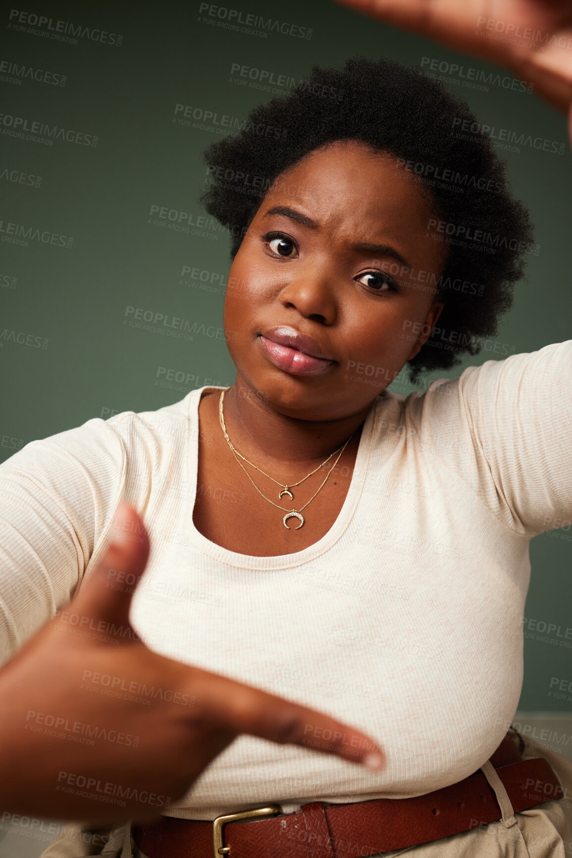 Buy stock photo Hand, frame and black woman portrait in studio with sign for photo, photography or fun picture on green background. Face, lady and beauty influencer with emoji finger for social media or selfie