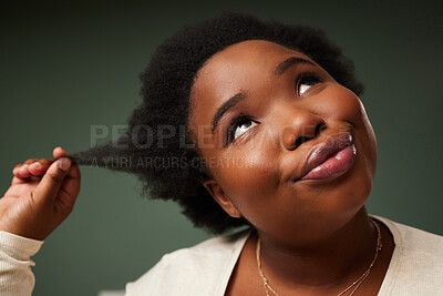 Buy stock photo Black woman thinking in studio about hair treatment, afro or skincare with beauty on green background. Face, girl and natural curly style for wellness, soft texture and glowing shine