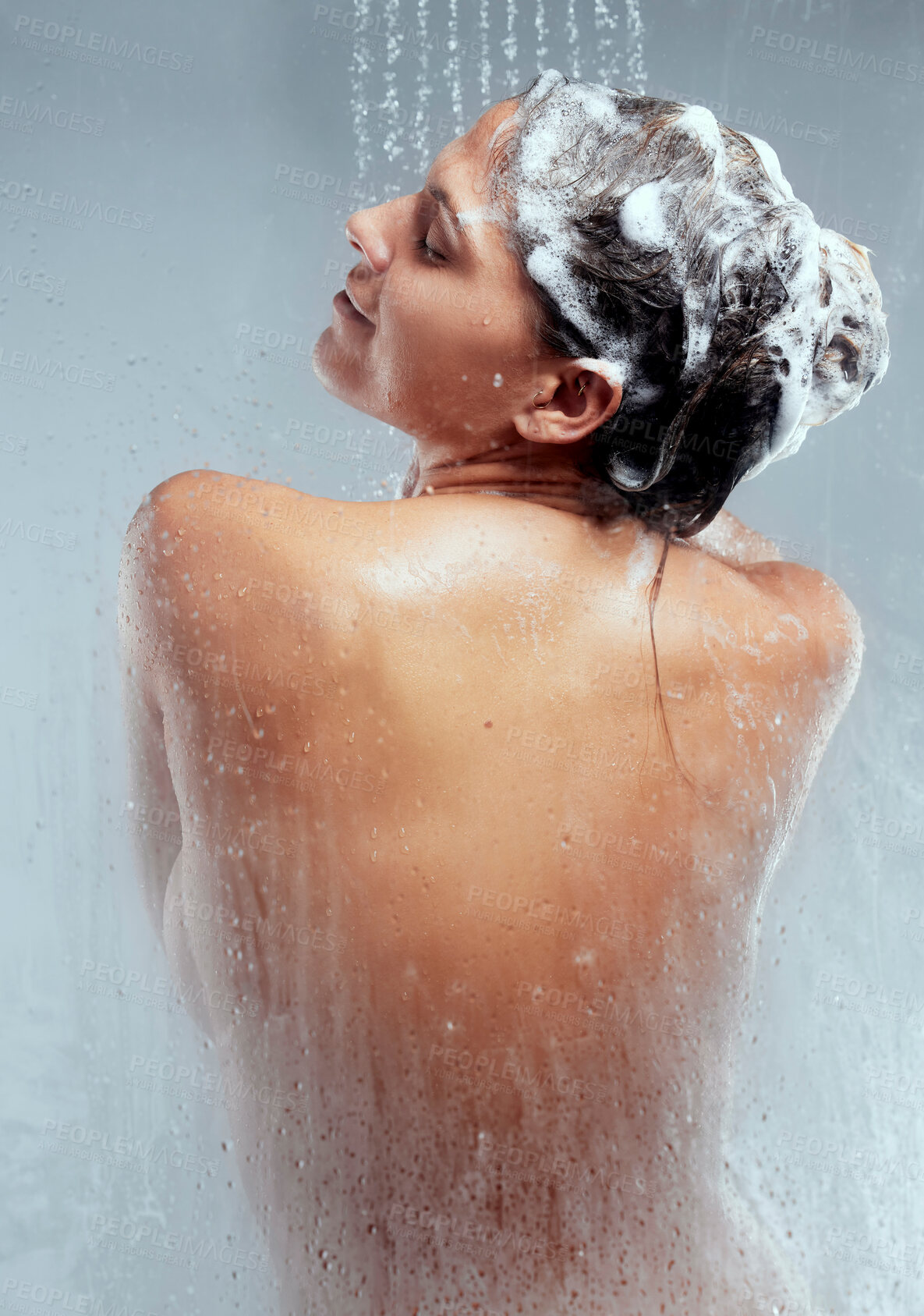 Buy stock photo Shampoo, studio or woman in shower for body hygiene, skincare and washing with wellness or water. Back, grey background and wet girl cleaning with soap and liquid for beauty, health and hair care
