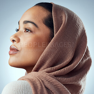 Buy stock photo Studio shot of a beautiful young woman wearing a headscarf against a grey background