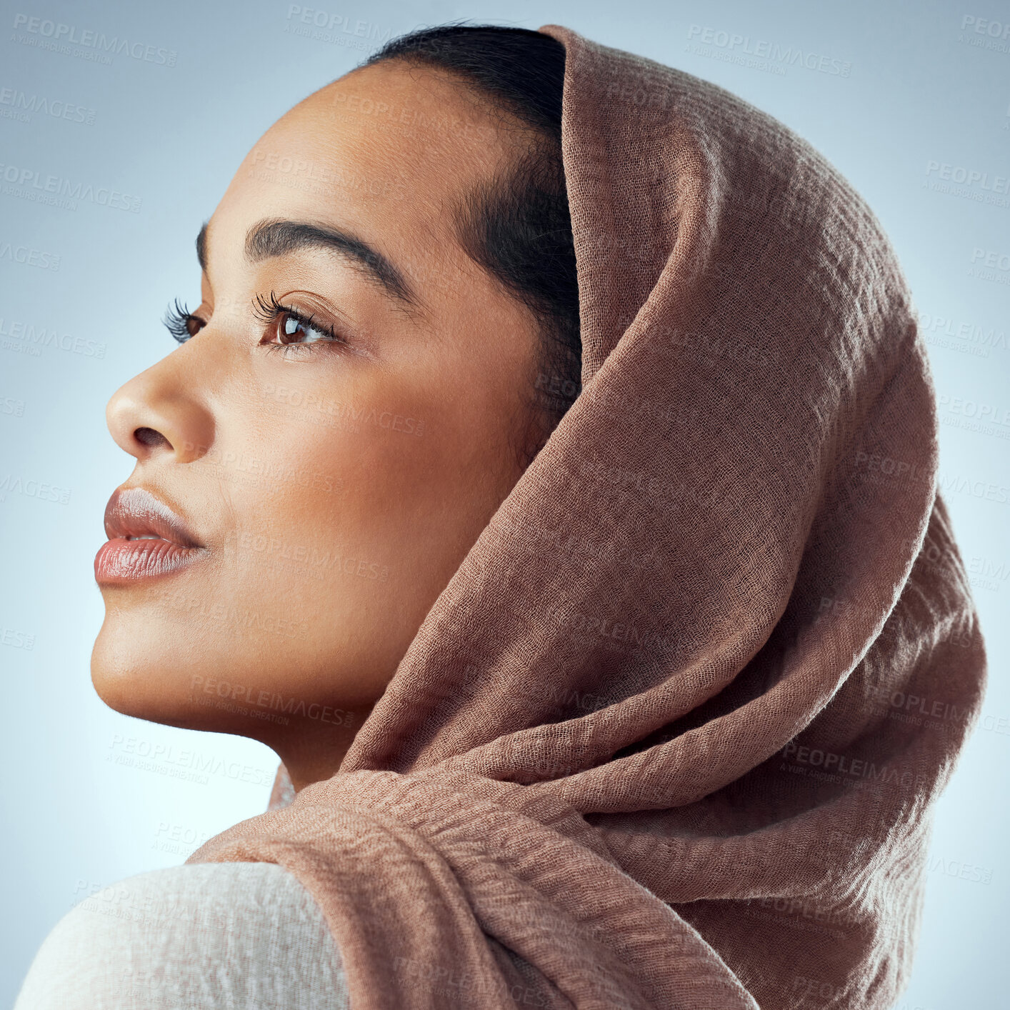 Buy stock photo Studio shot of a beautiful young woman wearing a headscarf against a grey background