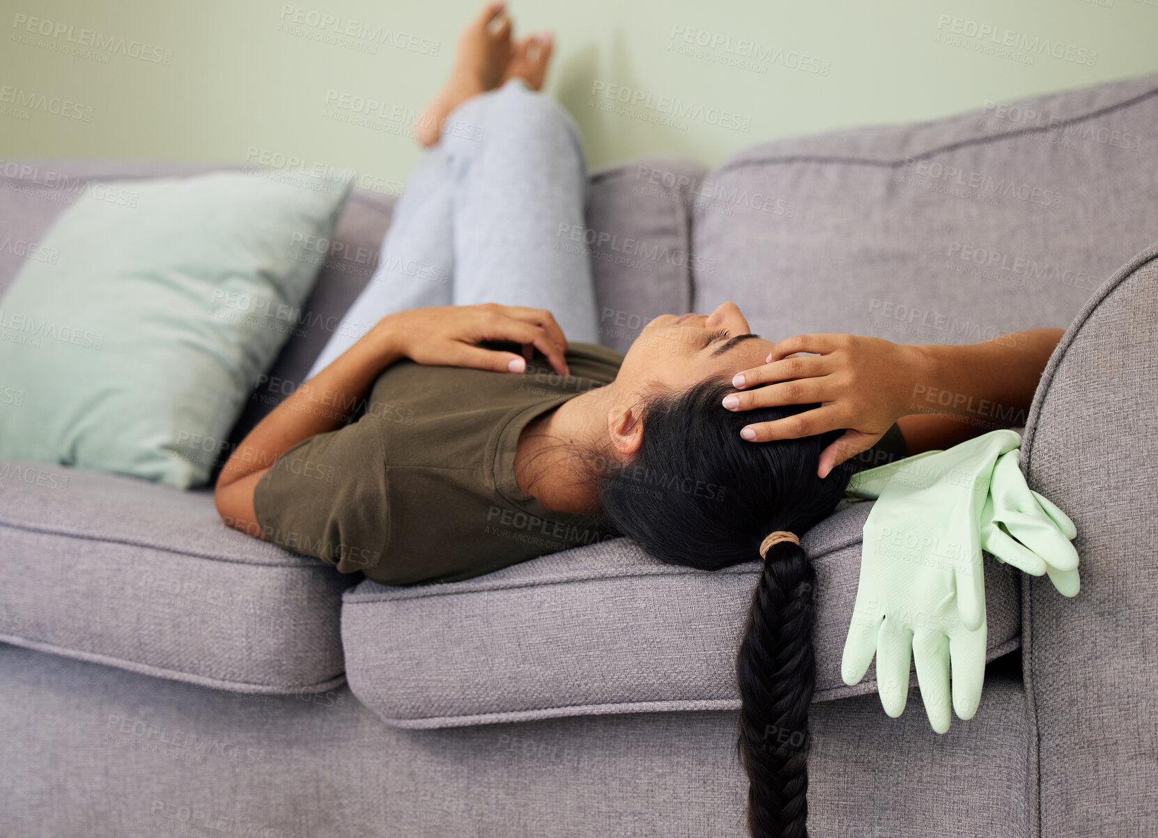 Buy stock photo Shot of a young woman sleeping on the couch at home