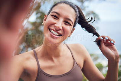 Buy stock photo Portrait of a sporty young woman taking selfies while exercising outdoors