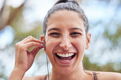 Buy stock photo Fitness, portrait and woman with earphones in nature for cardio, morning workout or marathon training. Wellness, laugh and female athlete for streaming music, radio or listening to podcast with bokeh