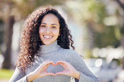 Buy stock photo Portrait, heart sign and woman with support, outdoor and trust with symbol for love, promotion and kindness. Face, happy person and girl with hand gesture, kindness and thank you with icon and smile