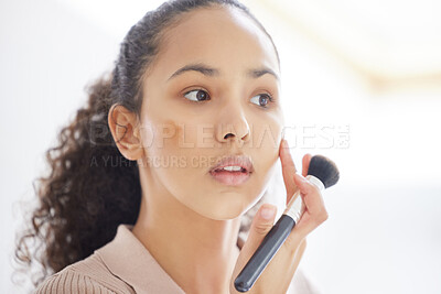 Buy stock photo Shot of a young woman applying makeup at home