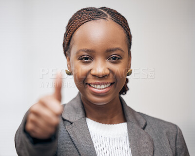 Buy stock photo Portrait of a young businesswoman showing thumbs up against a grey background