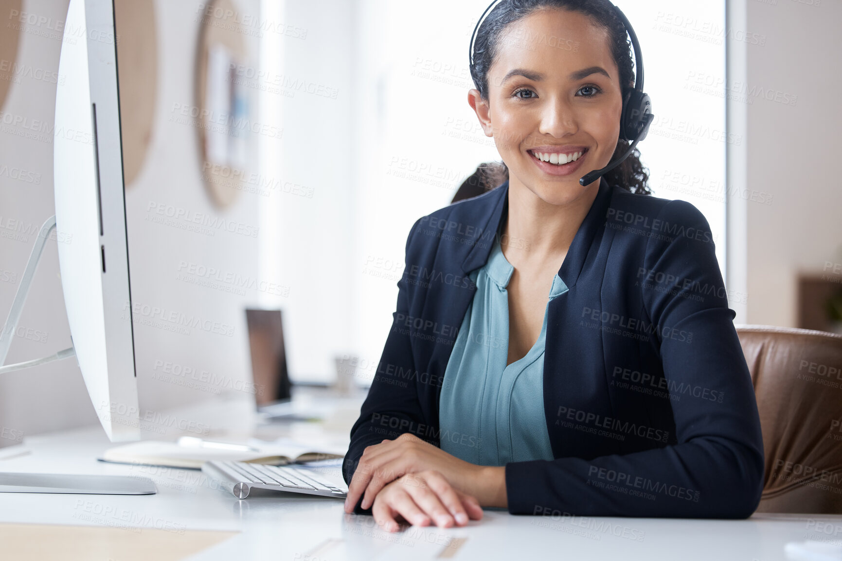 Buy stock photo Cropped portrait of an attractive young female call center agent working at her desk in the office