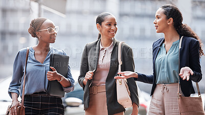 Buy stock photo Shot of a group of young businesswomen talking against a city background
