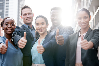 Buy stock photo Diversity, portrait of businesspeople and thumbs up smiling in a city background with a lens flare. Collaboration or teamwork, thank you or success and happy colleagues standing in urban outdoors