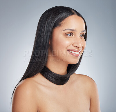 Buy stock photo Shot of an attractive young woman standing alone and posing with her hair wrapped around her neck in the studio
