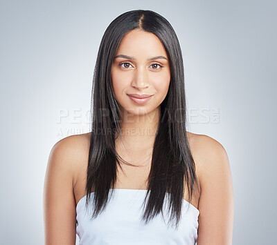 Buy stock photo Shot of an attractive young woman standing alone and posing in the studio