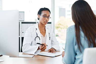 Buy stock photo Shot of a doctor recording a patient's information with her