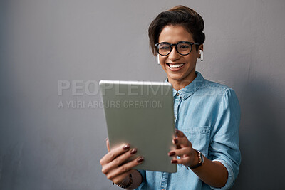 Buy stock photo Happy woman, tablet and listening to music isolated on gray background for university e learning, streaming and video. Gen z person or student on digital technology, audio and electronics application