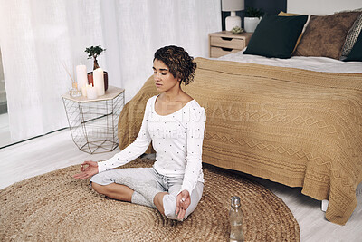 Buy stock photo Shot of an attractive young woman meditating on her bedroom floor at home