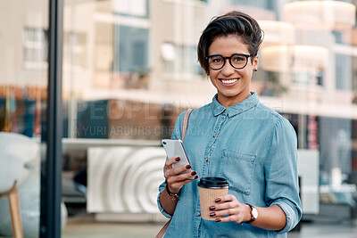 Buy stock photo Shot of an attractive young businesswoman standing alone outside and using her cellphone in the city