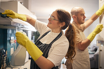 Buy stock photo Shot of a young couple cleaning their kitchen together