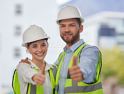 Buy stock photo Cropped portrait of two young construction workers giving thumbs up while standing on site outside