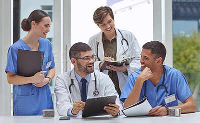 Buy stock photo Shot of a group of medical practitioners working together in a hospital boardroom