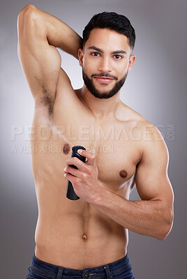 Buy stock photo Studio, portrait and man with deodorant, smile and body care with confidence, protection and skin. Skincare, health and happy male model with spray, armpit and product isolated on grey background