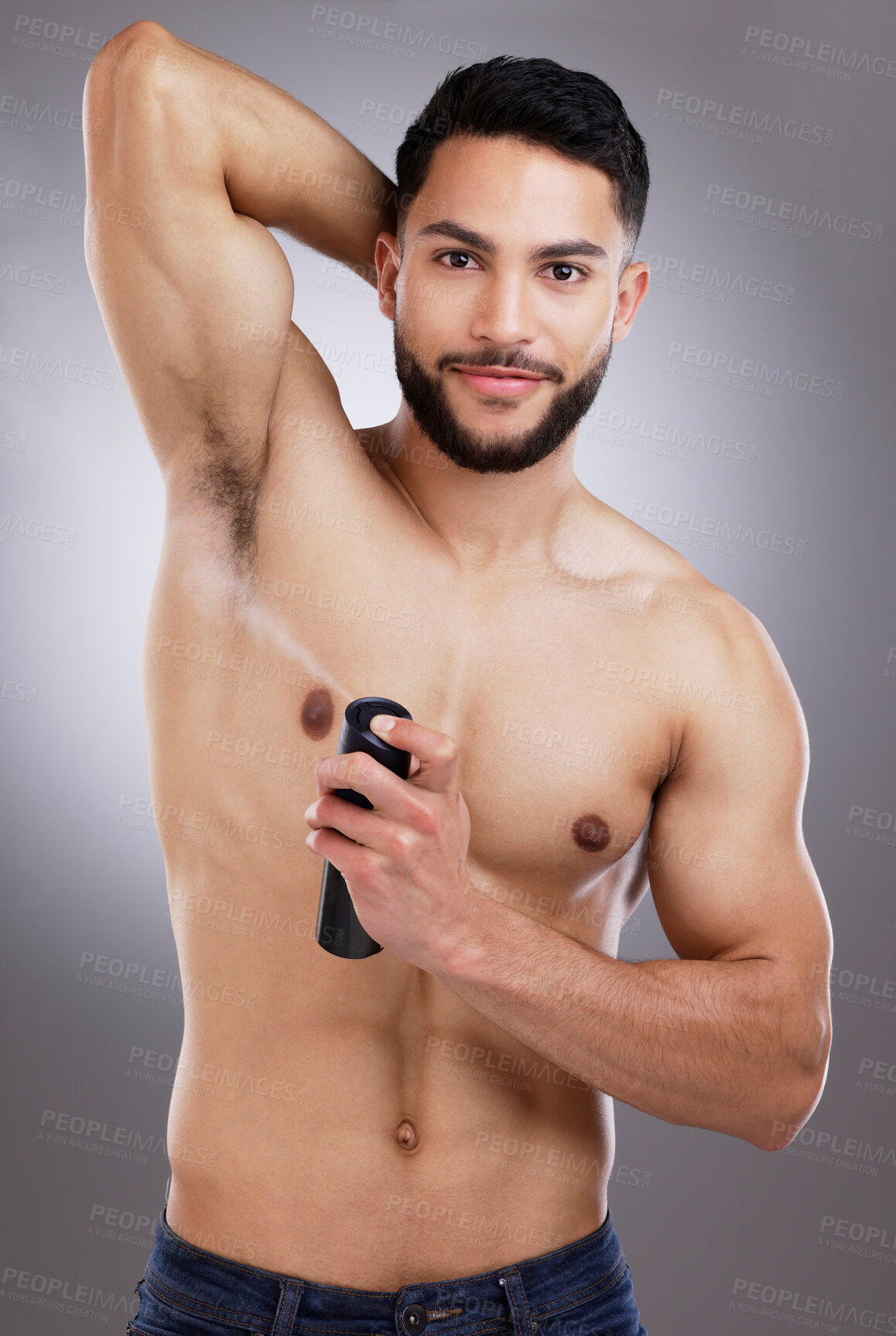 Buy stock photo Studio, portrait and man with deodorant, smile and body care with confidence, protection and skin. Skincare, health and happy male model with spray, armpit and product isolated on grey background