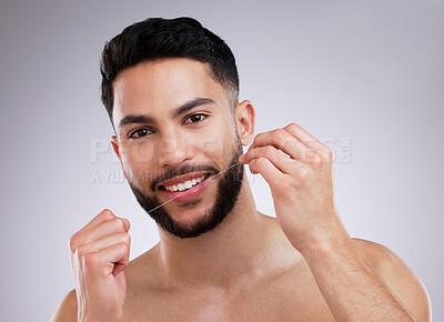 Buy stock photo Man, portrait and floss for teeth on studio background for oral health with fresh breath, wellness and cleaning. Face, male person and dental product on backdrop for tooth protection and mouth care