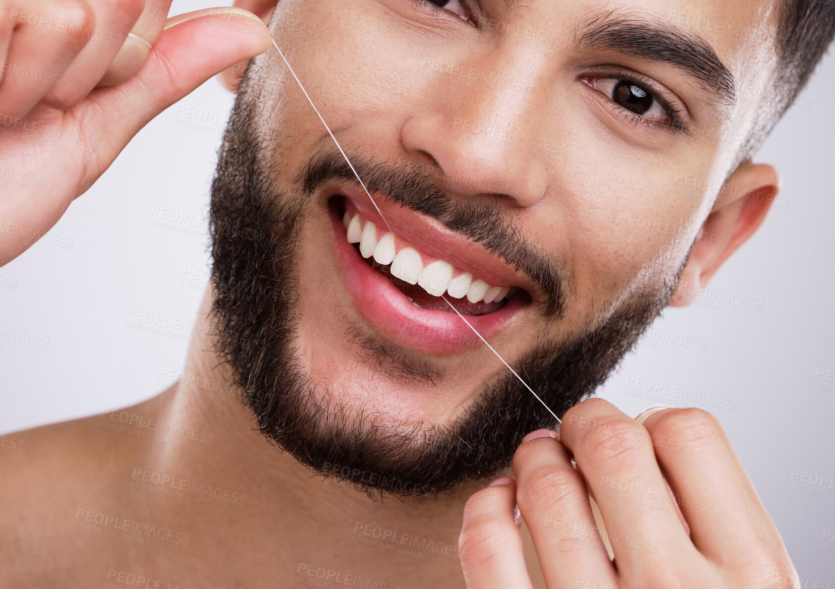 Buy stock photo Portrait, man and teeth with floss in studio for mouth care, oral hygiene and fresh breath. Morning routine, male person and smile with dental product for cavity prevention, protection and gum health