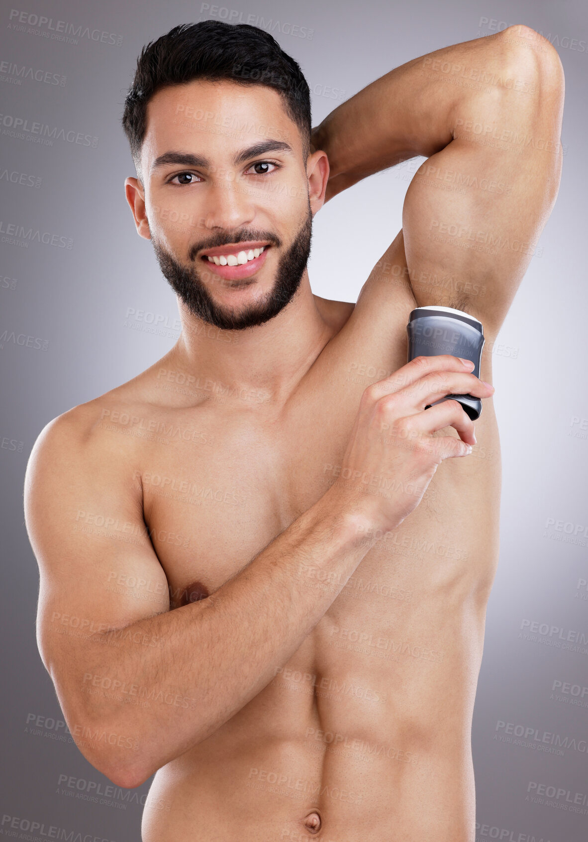 Buy stock photo Shot of a young man applying roll against a studio background