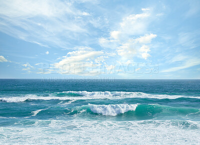 Buy stock photo Landscape banner view of waves rolling onto the seashore against a cloudy blue sky in summer. Peaceful scenic view of clear beach water in a tropical area. Relaxing natural environment on the coast