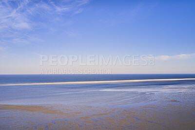 Buy stock photo Beautiful landscape of an empty beach against a blue sky background on a summer morning. A peaceful and quiet view of the ocean and the sea shore with copy space on a spring day