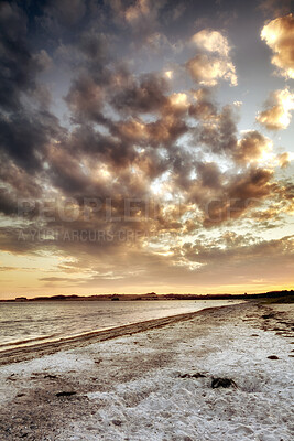 Buy stock photo Beach view of sky and clouds at sunset with calm sea water in summer. Nature landscape of a coastline with a cloudy scene over the horizon. Seaside tides and currents on a bright and beautiful day